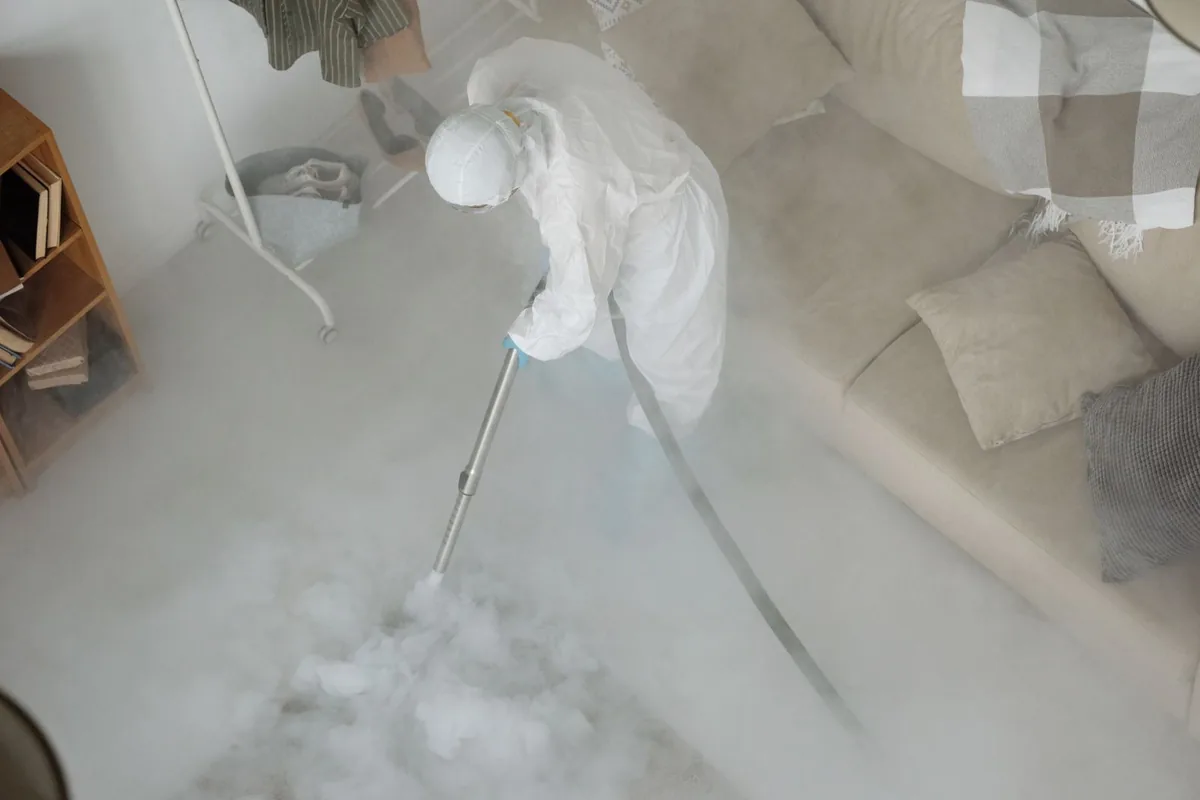 Biohazard cleanup technician in protective equipment, Desloge, MO